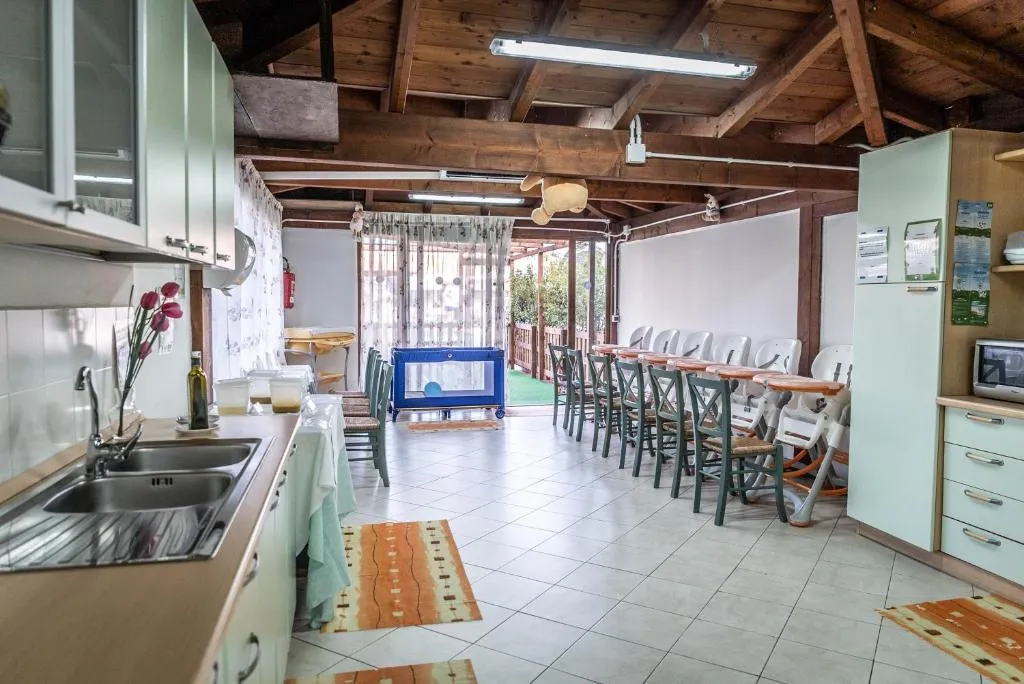 Cucina attrezzata per bambini con seggioloni e tavolo lungo